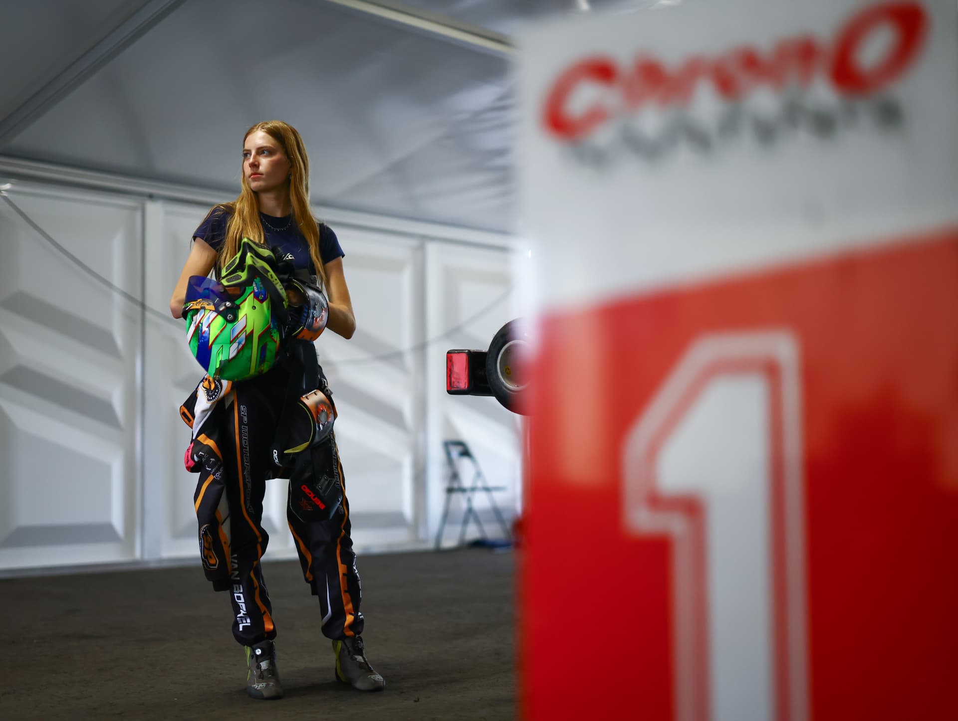 Lieke van Boekel holding her helmet in the paddock at Berghem