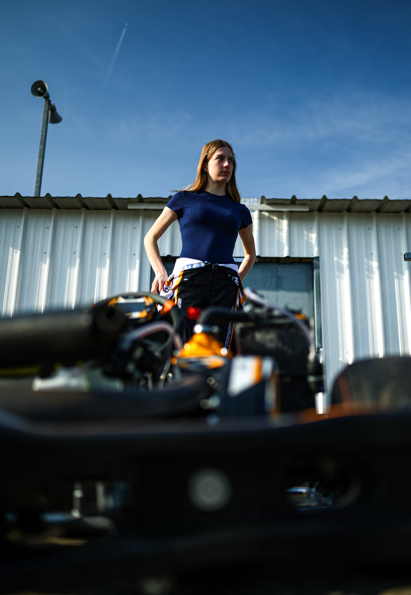 Lieke van Boekel, hands on hips, talking to another driver